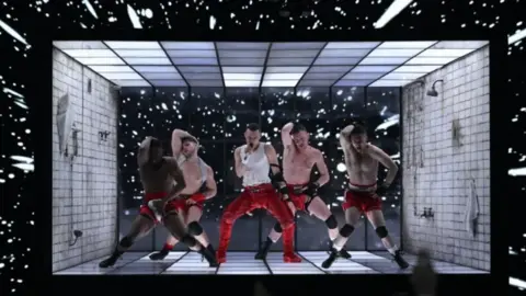 Getty Images Olly Alxander performing his song on stage with dancers around him