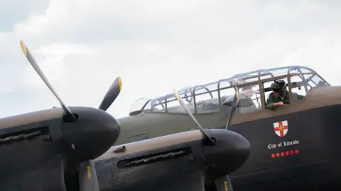 Joe Giddens/PA BBMF flight engineer Rick Gomez in the cockpit of PA474 before she took off