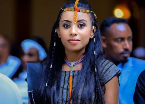 Senakebeki Girma Woman wearing beads in her hair