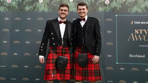 PA Media Two men dressed in kilts at Aintree Ladies Day 2024