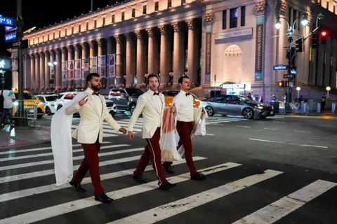 Reuters Workers believed to be a part of the reported wedding between singer Taylor Swift and National Football League (NFL) player Travis Kelce, crosses a road outside Madison Square Garden, in New York City, U.S., July 3, 2026.