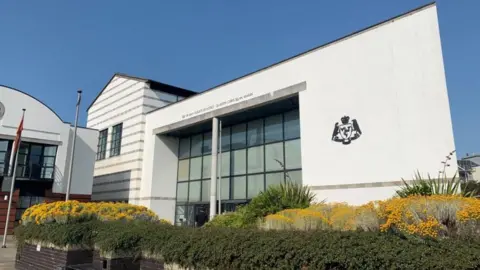 BBC Douglas Courthouse, a large white building in front of a blue sky