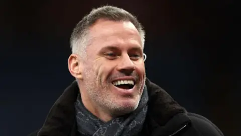 Jamie Carragher pictured laughing while working as a pundit
