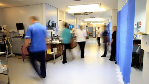 PA Media Hospital corridor with blurred images of staff as they work.