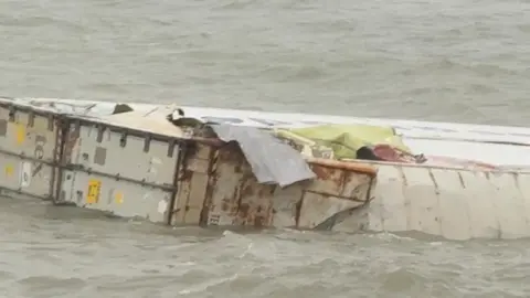 A close up of a floating container which appears to be damaged.