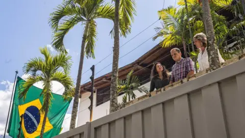 Claudia Macero (L), Pedro Uchurrurtu (C) and Magalli Meda are photographed greeting the media in August from the embassy where they had been sheltering.