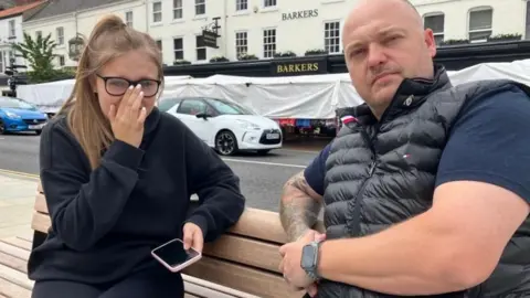 Paige and Adam Davies on a bench in Northallerton