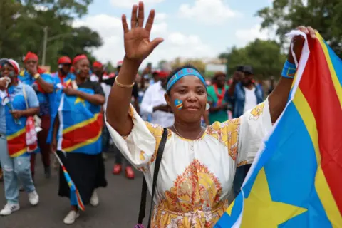 AFP A Congolese woman protests against the conflict in her country in South Africa.