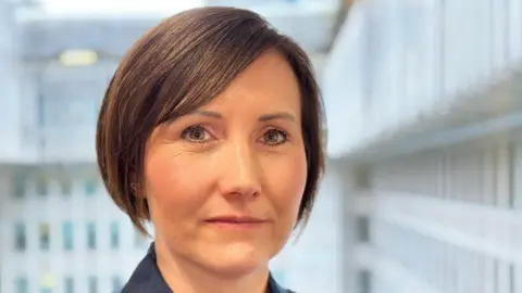 A head shot of Lucy Paddick, who has a brown bob with a side parting