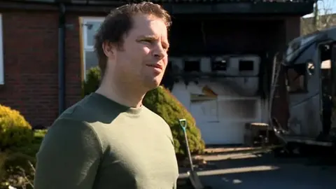 Sean Ivey outside his home