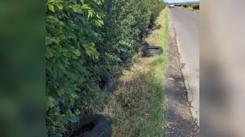 Burnham-on-Sea.com Tyres in a ditch with view of a country lane