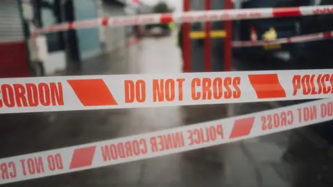 Getty Images Crime scene tape in street