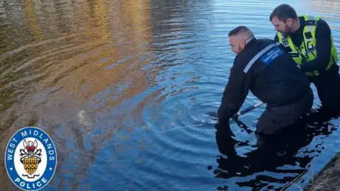 Police pulling a bike from the canal