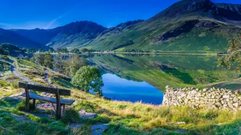 Getty Images Wooden bench overlooking Buttermere in the Lake District