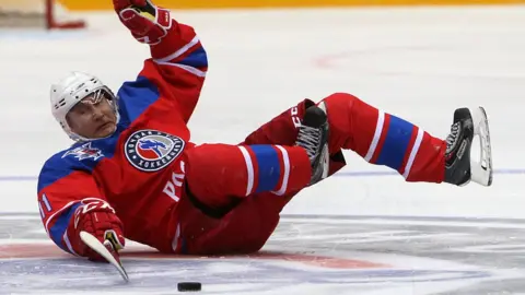 Getty Images Vladimir Putin slipping while playing ice hockey