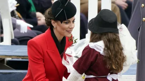 The Princess of Wales (left) receives a bunch of flowers during a St David's Day visit to the 1st Battalion Welsh Guards at Combermere Barracks in Windsor, Berkshire