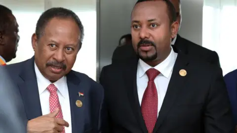 Getty Images Prime Minister of Ethiopia Abiy Ahmed (R) and Prime minister of Sudan Abdalla Hamdok (L) attend the opening session of the 33rd African Union Heads of State Summit in Addis Ababa, Ethiopia on February 09, 2020.