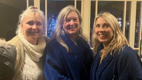 Left to right: Coach Jo Penney and swimmers Annabel Other and Delia Adey