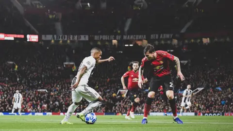Juventus' Douglas Costa takes on Manchester United defender Victor Lindelof at Old Trafford