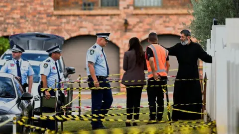 Reuters Police enter the Assyrian Christ The Good Shepherd Church with a clergyman in Wakeley, in Sydney, Australia, April 17, 2024.