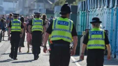 Getty Images Police patrol the beach in Bournemouth on Thursday 25 June