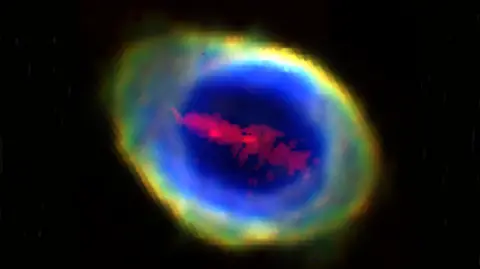 The Ring Nebula in space showing the "red iron bar" in a line across the middle of it. 