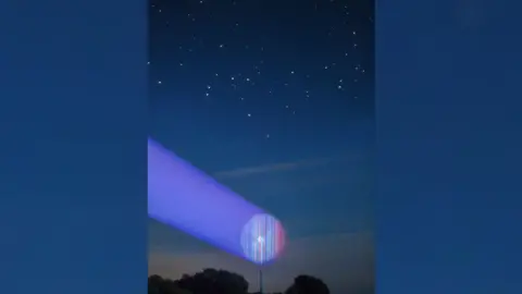 University of Reading A wind turbine with a circular version of the blue-to-red climate stripes projected into the arc of its blades, underneath a starry sky