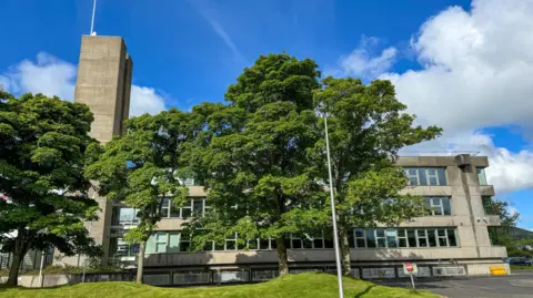 The Scottish Borders Council building - a functional 1960s design - behind some trees
