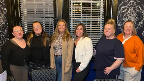 BBC Image shows a group of six woman standing in a line 