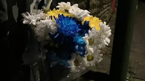 floral tributes laid on the street