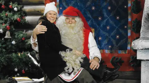 Polly Arrowsmith Polly Arrowsmith sitting on the lap of Father Christmas