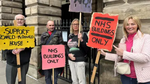 BBC Protestors outside Liverpool Town Hall holding placards