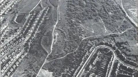 Friends of Wincobank Hill Black-and-white satellite photo of land showing houses and grassland.