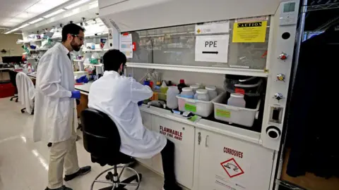 Getty Images Scientists testing store-bought milk in a lab