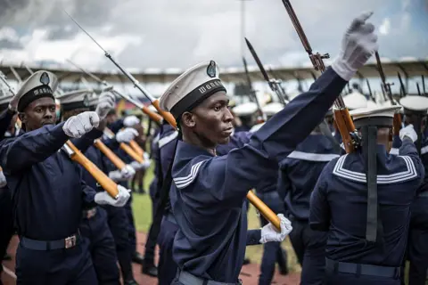 Marco Longari / AFP / Getty Images Members of the Tanzanian navy march in formation as they take part in a rehearsal for the inauguration of Zanzibar's president - Friday 31 October 2025.