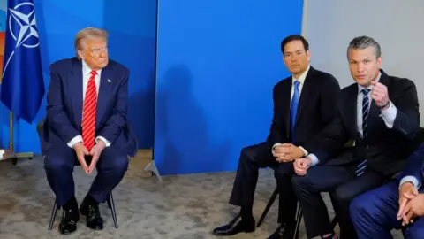 U.S. Secretary of Defense Pete Hegseth speaks next to U.S. Secretary of State Marco Rubio with U.S. President Donald Trump