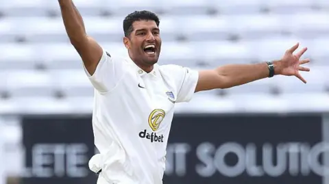 Gurinder Sandhu celebrates taking a wicket for Sussex against Durham