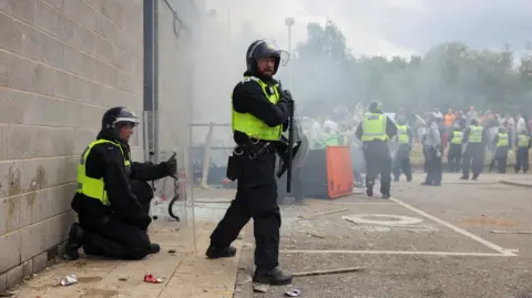 Reuters Police officers outside the Holiday Inn Express in Manvers