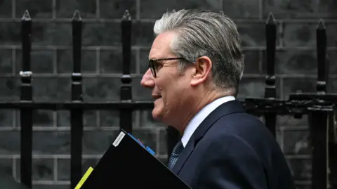 Getty Images Sir Keir Starmer leaves No 10 carrying a folder.