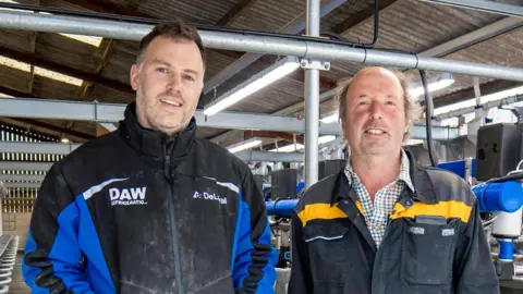 Connor Moor/ Daw Refrigeration A photo of two men inside a factory. They are both smiling at the camera. 