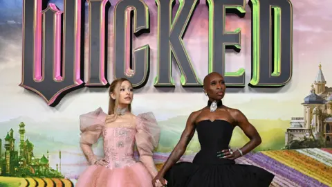 Getty Images Ariana Grande and Cynthia Erivo pose in their gowns at the Wicked premiere in Australia 