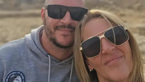 Adele Cook A man and woman in sunglasses.
