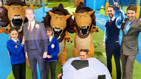 Howard Junior School Pupils and teachers with cut-outs of footballers