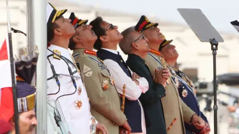 Getty Images Pakistan's then Prime Minister Imran Khan and President Arif Alvi watch Pakistan's Air Force fighter jets perform during the Pakistan Day parade in Islamabad on March 23, 2022