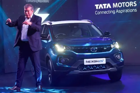 Getty Images Guenter Butschek, CEO and Managing Director of Tata Motors Worldwide, gestures during the launch of the Tata Nexon EV electric car, in Mumbai on January 28, 2020