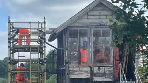 NETWORK RAIL Network Rail engineers stripping out the roof of the signal box in Wye.