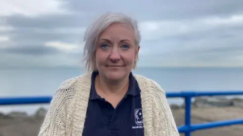 Diane Wilson standing on Larne Promenade