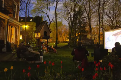 Madeleine Hordinski Maddie's family watches a movie outside with their neighbours