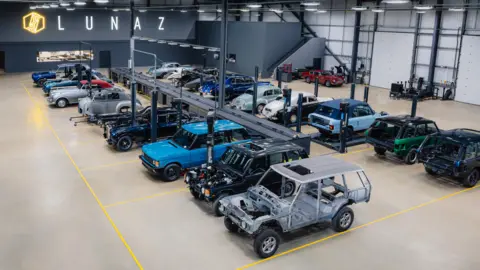 Lunaz Car chassis from different brands lined up in a factory