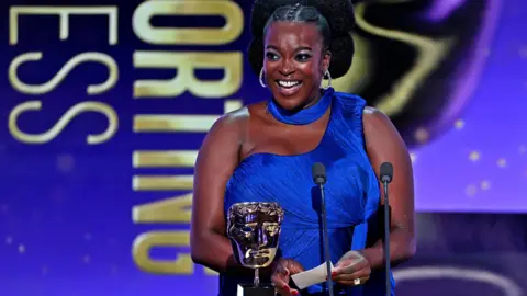 Wunmi Mosaku accepts the Supporting Actress Award for 'Sinners' on stage during the EE BAFTA Film Awards 2026 at The Royal Festival Hall on February 22, 2026 in London, England
